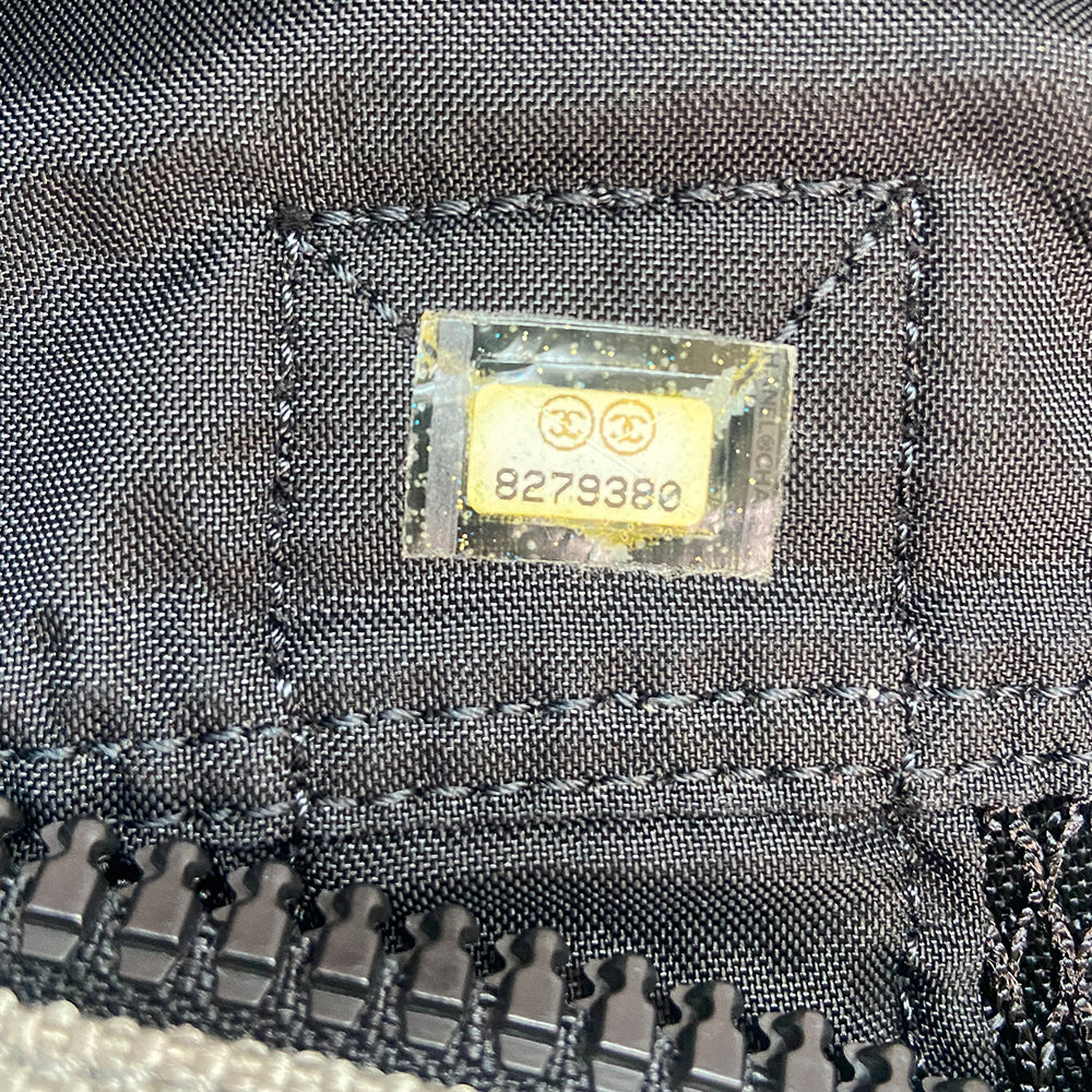 Chanel sport canvas and mesh large grey/black/cream duffle bag by Karl Lagerfeld for Chanel, 2003/2004 zipper closure and boxed rubber CC front logo, 2 exterior end pockets and one exterior front pocket. Double Chanel embossed satin webbing logo carry straps. Serial number sticker attached. Made in Italy