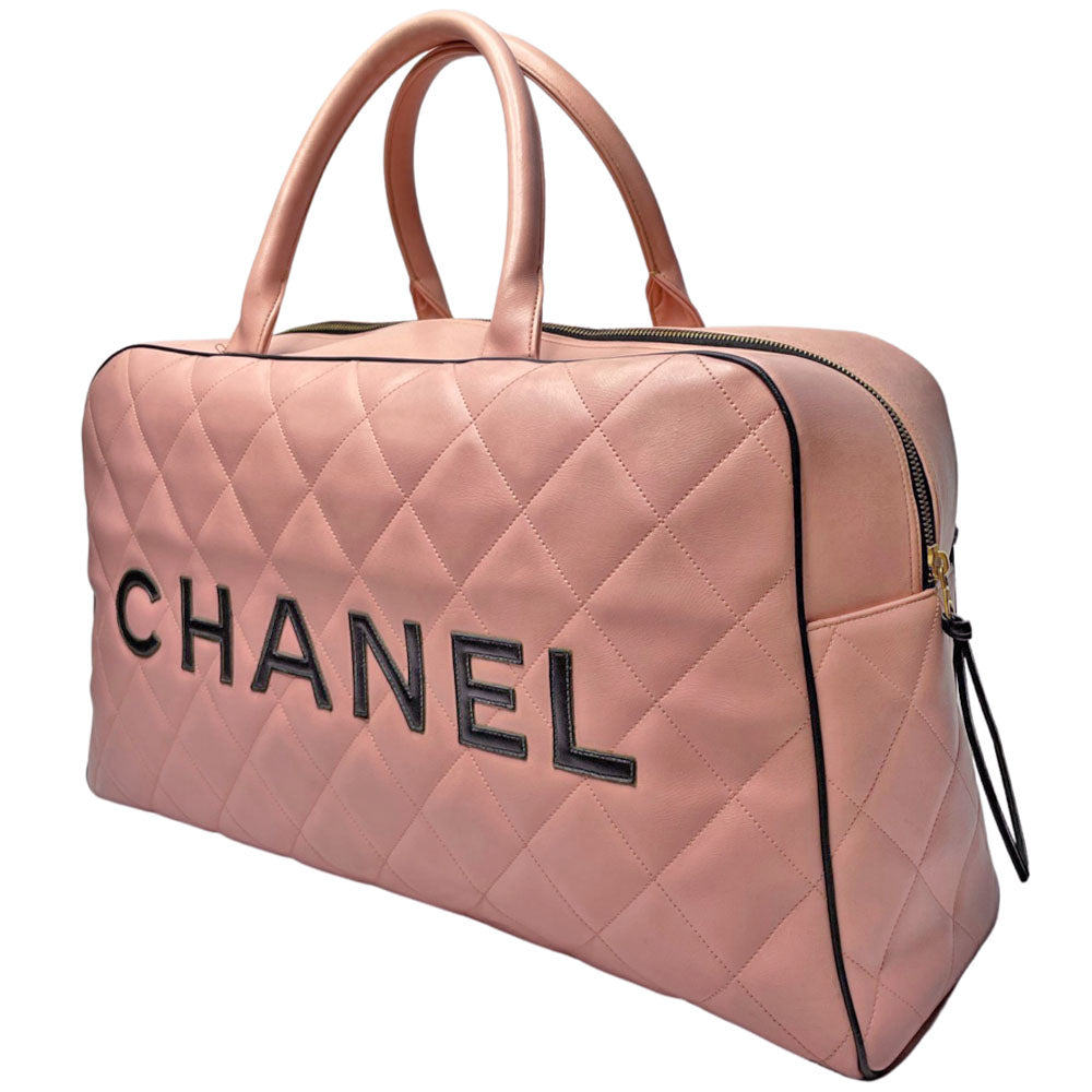 Chanel pink diamond quilted leather boston bag by Karl Lagerfeld for Chanel 1995 with contrasting black leather piping, trim and stitched CHANEL letters front logo. Gold tone zippers and feet, exterior zip pocket, top zipper closure, lack leather interior with one interior zip pocket. Made in France