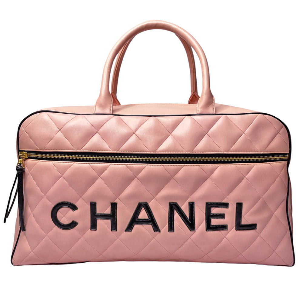Chanel pink diamond quilted leather boston bag by Karl Lagerfeld for Chanel 1995 with contrasting black leather piping, trim and stitched CHANEL letters front logo. Gold tone zippers and feet, exterior zip pocket, top zipper closure, lack leather interior with one interior zip pocket. Made in France