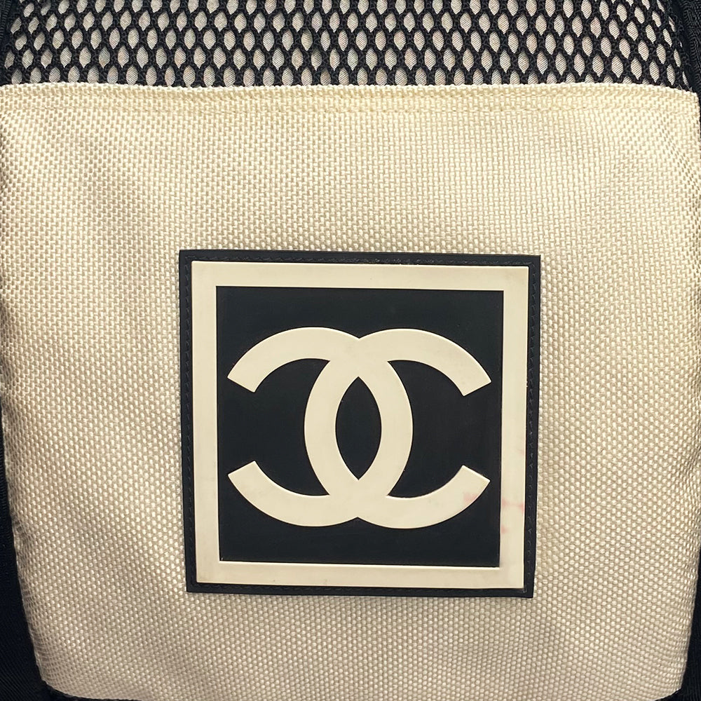 Chanel sport canvas and mesh large grey/black/cream duffle bag by Karl Lagerfeld for Chanel, 2003/2004 zipper closure and boxed rubber CC front logo, 2 exterior end pockets and one exterior front pocket. Double Chanel embossed satin webbing logo carry straps. Serial number sticker attached. Made in Italy