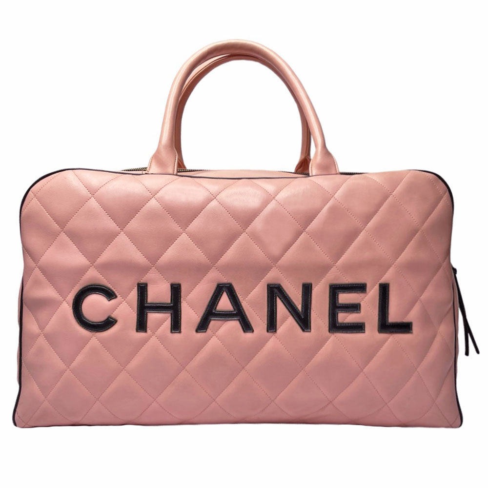 Chanel pink diamond quilted leather boston bag by Karl Lagerfeld for Chanel 1995 with contrasting black leather piping, trim and stitched CHANEL letters front logo. Gold tone zippers and feet, exterior zip pocket, top zipper closure, lack leather interior with one interior zip pocket. Made in France