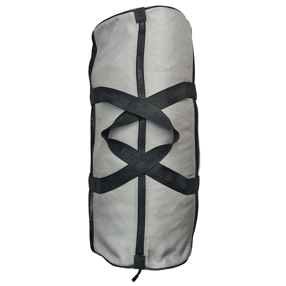 Chanel sport canvas and mesh large grey/black/cream duffle bag by Karl Lagerfeld for Chanel, 2003/2004 zipper closure and boxed rubber CC front logo, 2 exterior end pockets and one exterior front pocket. Double Chanel embossed satin webbing logo carry straps. Serial number sticker attached. Made in Italy