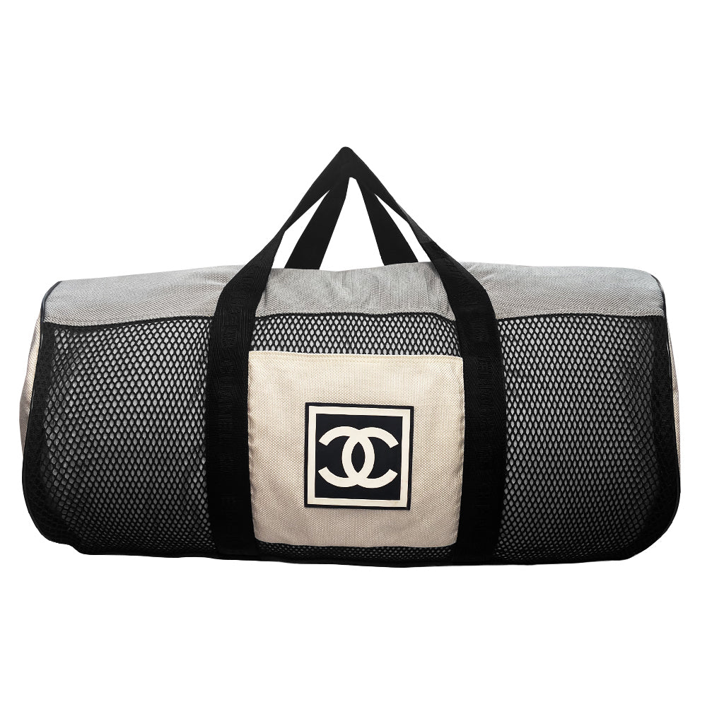 Chanel sport canvas and mesh large grey/black/cream duffle bag by Karl Lagerfeld for Chanel, 2003/2004 zipper closure and boxed rubber CC front logo, 2 exterior end pockets and one exterior front pocket. Double Chanel embossed satin webbing logo carry straps. Serial number sticker attached. Made in Italy