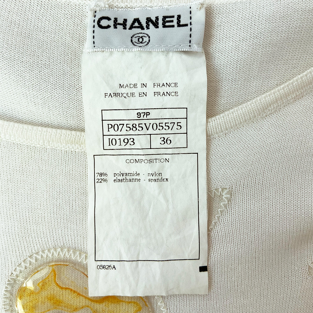Chanel sleeveless white knit top by Karl Lagerfeld for Chanel 1997 embellished with CC logo colorful vinyl appliqué camellia flowers at front and back. Tag size: 36. Made in France