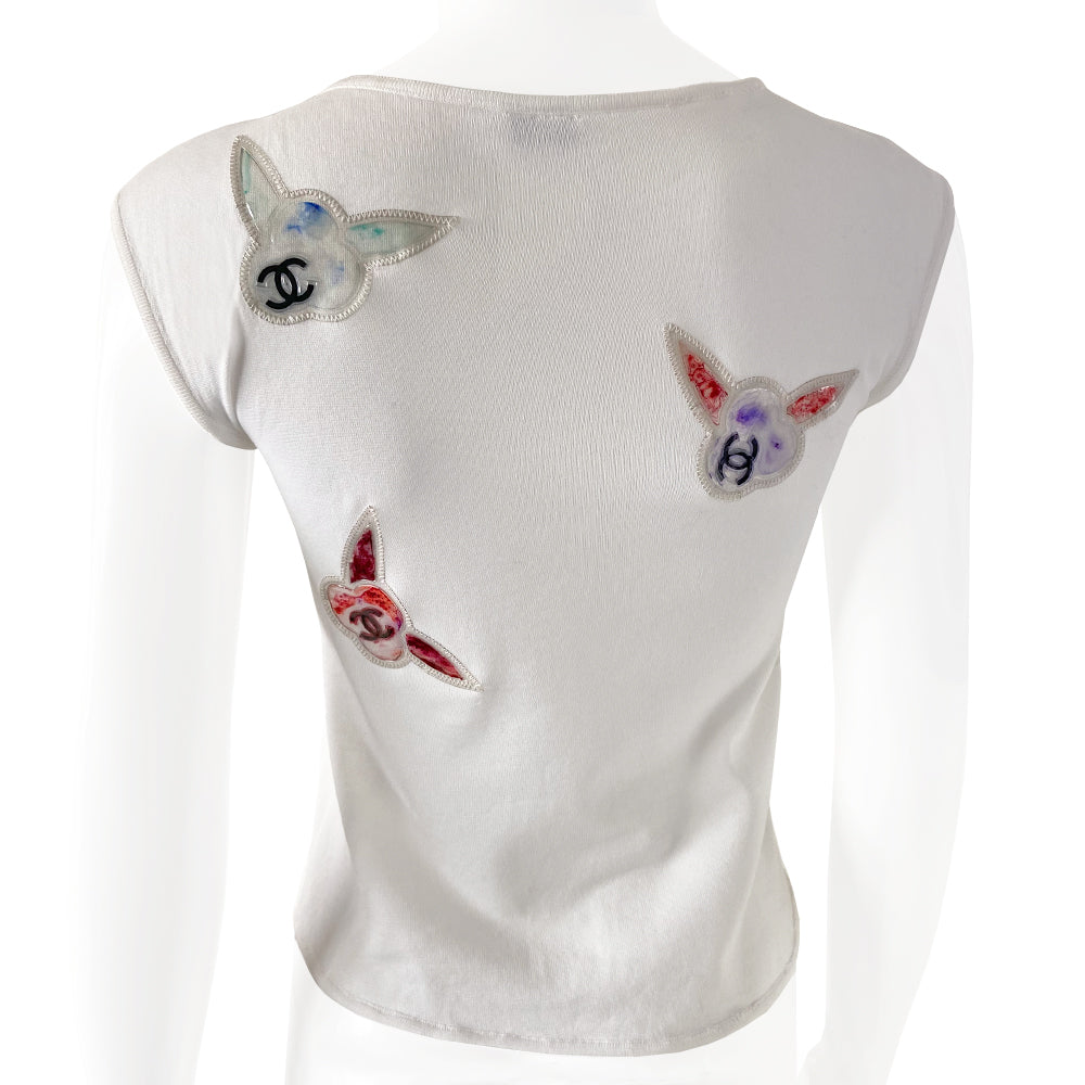 Chanel sleeveless white knit top by Karl Lagerfeld for Chanel 1997 embellished with CC logo colorful vinyl appliqué camellia flowers at front and back. Tag size: 36. Made in France