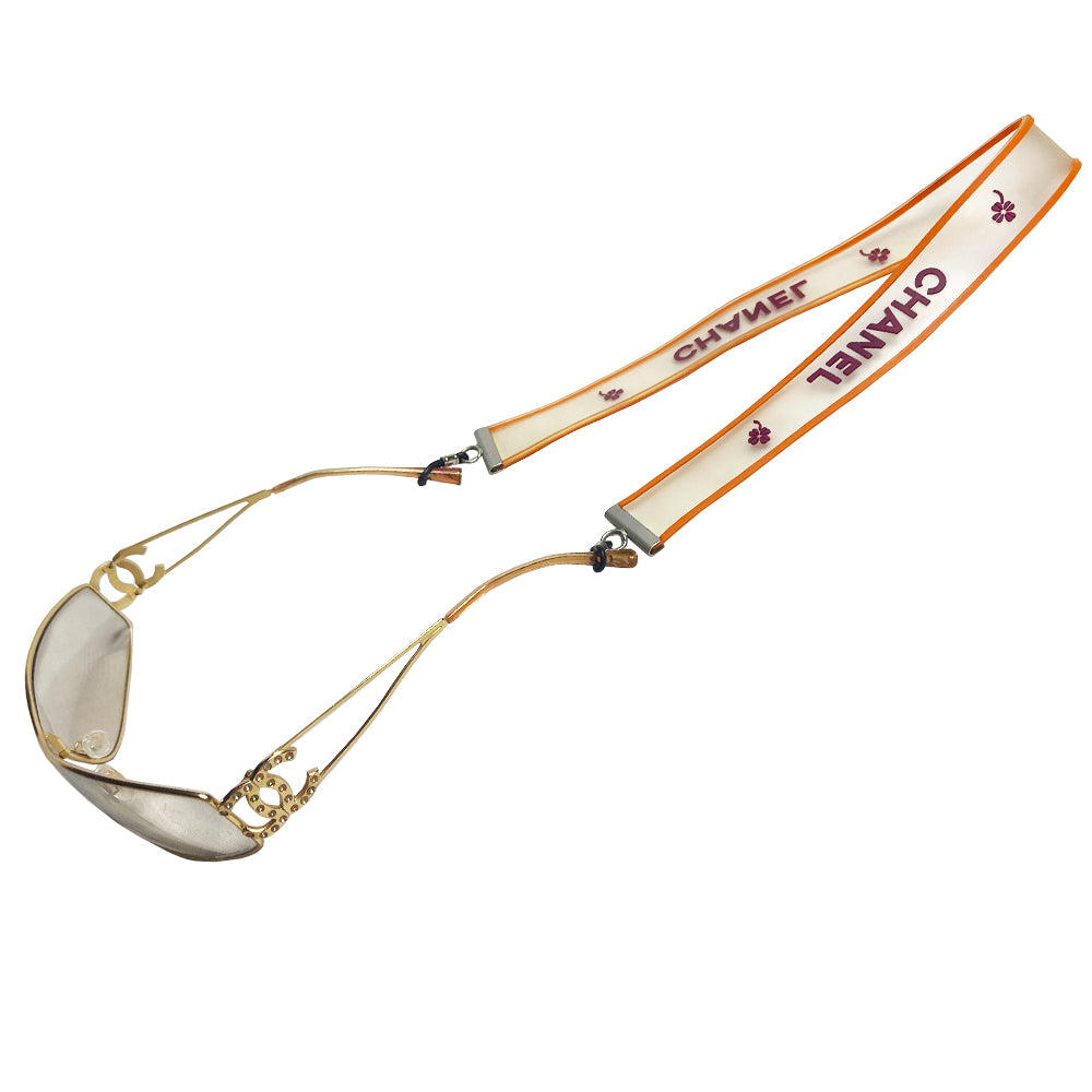 Chanel rubber sunglasses chain Karl Lagerfeld for Chanel, Autumn 2001 with translucent clear band with orange edges and burgundy printed out CHANEL logos and clovers. Adjustable rubber closures with silver-tone beaded slider. Made in France