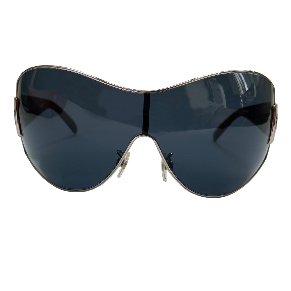 Chanel Oversized Shield Sunglasses with oversized lens surrounded by silver-tone metal frame, wide arms, square CC silver logo at sides that wrap on to the lens Condition: Excellent, no scratches on lens. Main Color: Black with black lens Case and dust cover included. Made in Italy.