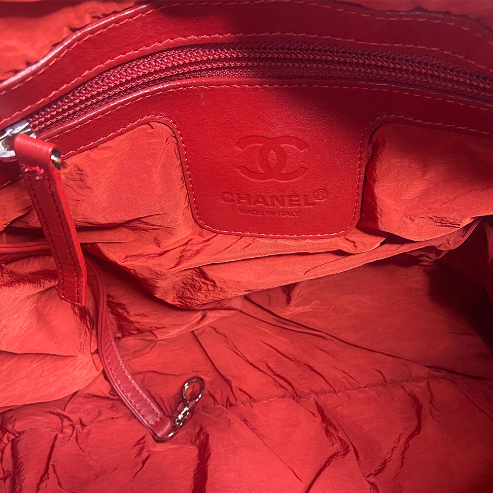 Chanel lightweight quilted green nylon shoulder bag by Karl Lagerfeld for Chanel, 2009/2010 with brown CC embossed brown leather accents at strap ends & around exterior silver-tone logo engraved outer pocket zipper. Interlocking CC stitched bottom logo. Zip top closure with red nylon interior, one zip pocket. Made in Italy