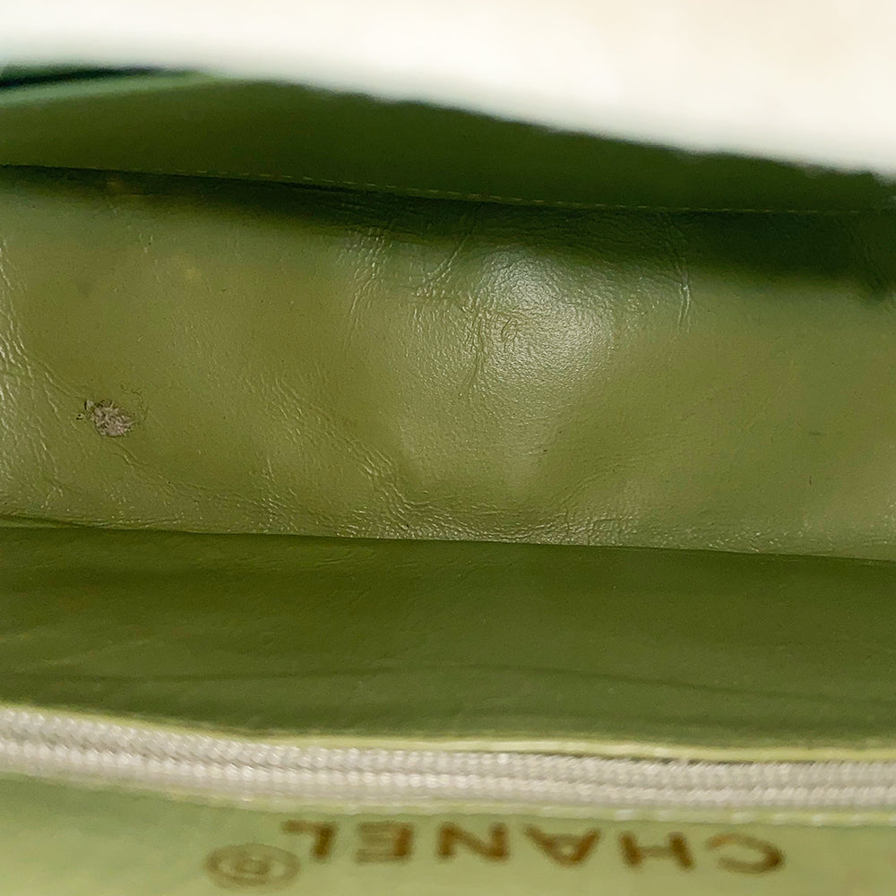 Chanel suede camera bag by Karl Lagerfeld for Chanel, 1991-94. Pistachio color quilted suede, top zipper, etched gold ball and tassels zipper pull, suede and gold chain shoulder strap. Outer flap pocket with engraved gold CC turn-lock, tonal leather lining, patch slip and zippered pocket with gold zipper pull. Made in France