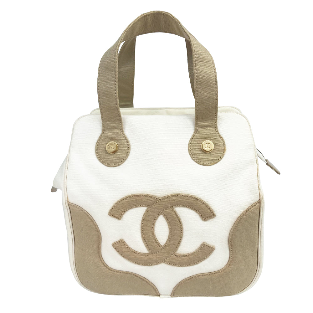 Chanel canvas Marshmallow Tote by Karl Lagerfeld for Chanel 2003-2004. White canvas tote with taupe handles and accent, stitched interlocking CC front logo, protective bottom feet. Gold-tone top zipper and hardware Chanel printed textile interior with one interior zip pocket. Made in Italy