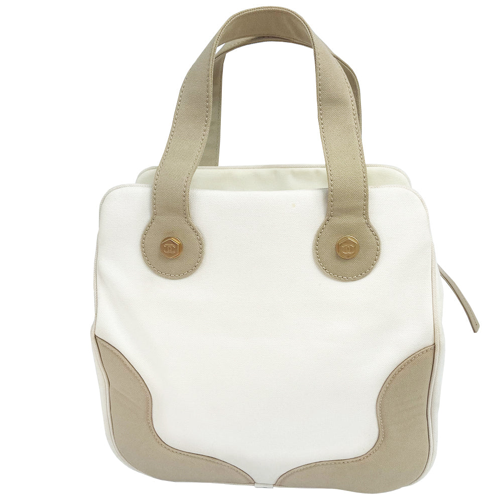 Chanel canvas Marshmallow Tote by Karl Lagerfeld for Chanel 2003-2004. White canvas tote with taupe handles and accent, stitched interlocking CC front logo, protective bottom feet. Gold-tone top zipper and hardware Chanel printed textile interior with one interior zip pocket. Made in Italy