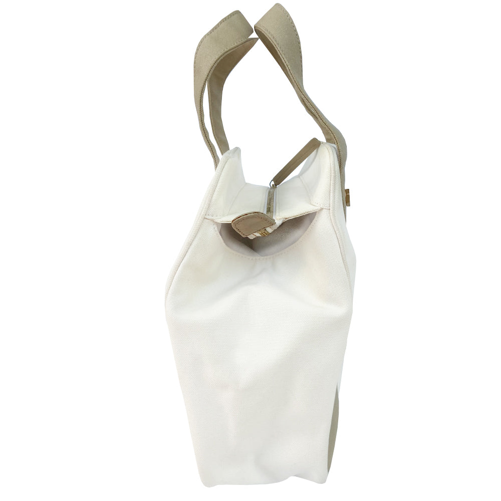 Chanel canvas Marshmallow Tote by Karl Lagerfeld for Chanel 2003-2004. White canvas tote with taupe handles and accent, stitched interlocking CC front logo, protective bottom feet. Gold-tone top zipper and hardware Chanel printed textile interior with one interior zip pocket. Made in Italy