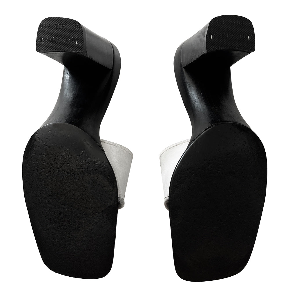 Chanel white square toe slip on mules with black leather covered block heels, leather upper with embroidered interlocking CC logo and edging. White and black leather insole with leather bottom sole. Made in Italy
