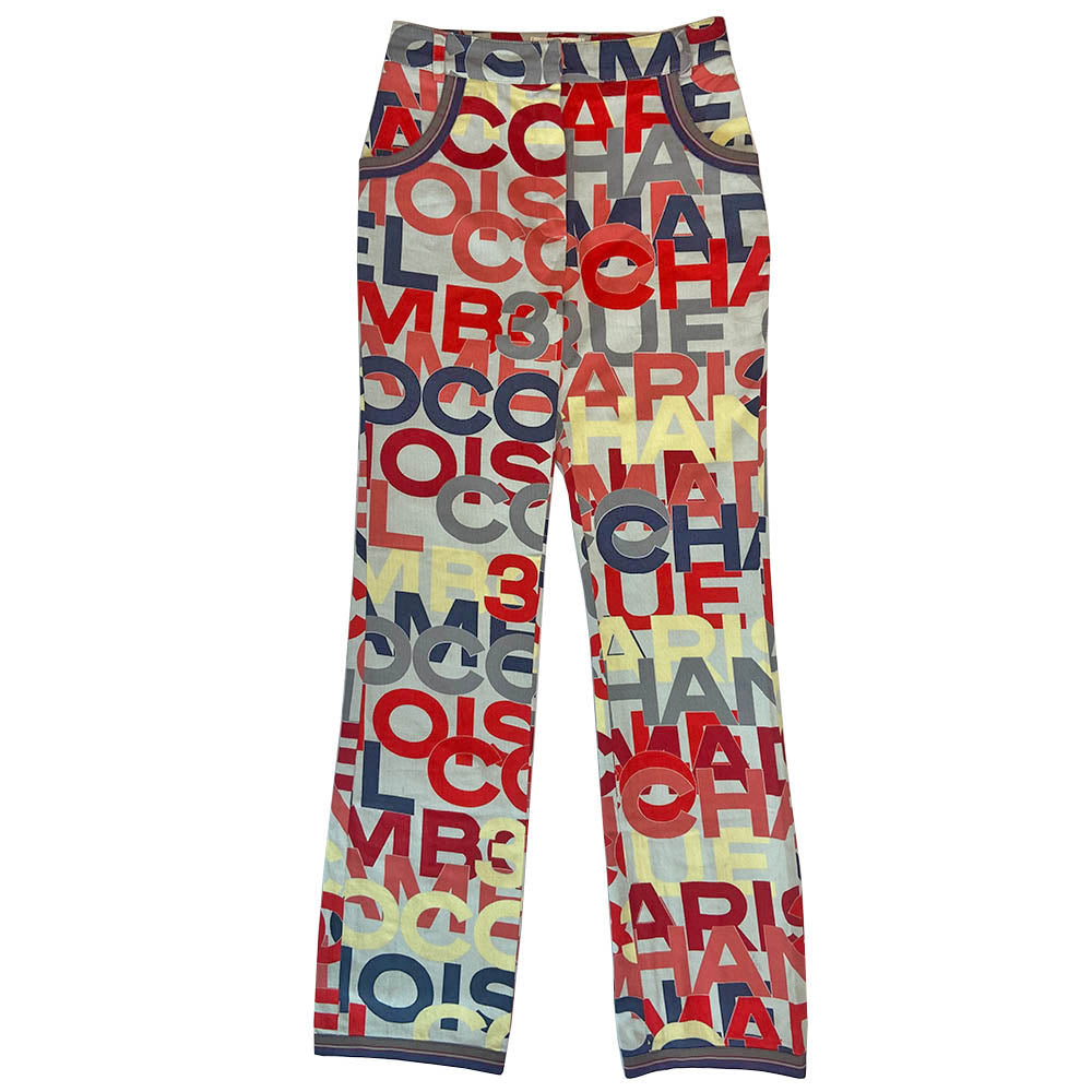 Chanel Identification Collection high rise graphic letters denim pants from Karl Lagerfeld for Chanel, 2000 with panel details at back hemline, zip fly with hook closure, bold all over colorful lettering spell out CHANEL, COCO, PARIS. Striped knit accent at front pockets and bottom hem. Made in Italy