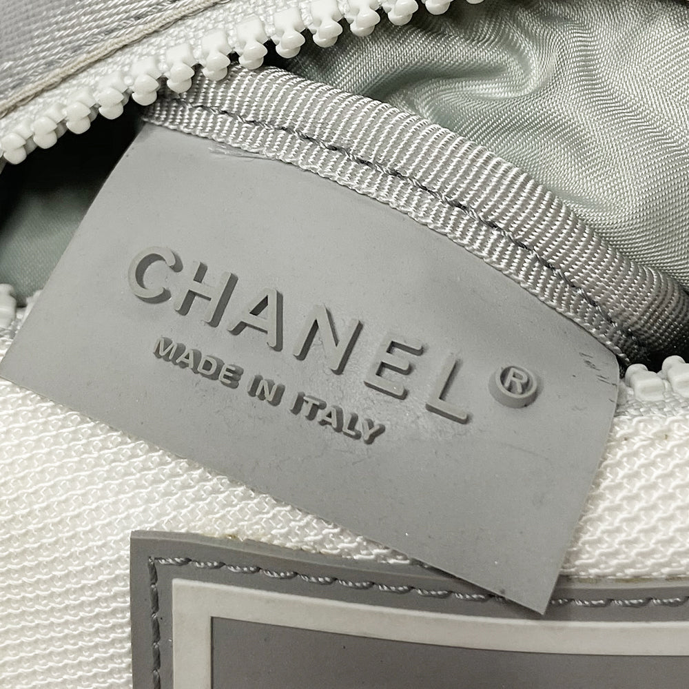 Chanel Sports Line white with light grey accent canvas arm pouch by Karl Lagerfeld for Chanel, spring 2001. CHANEL embossing and CC logo on front webbing accent strap, box CC rubber logo at center, double elastic slip on arm bands. Zip front with white zipper pull closure, light grey textile interior and Chanel rubber tag. Made in Italy