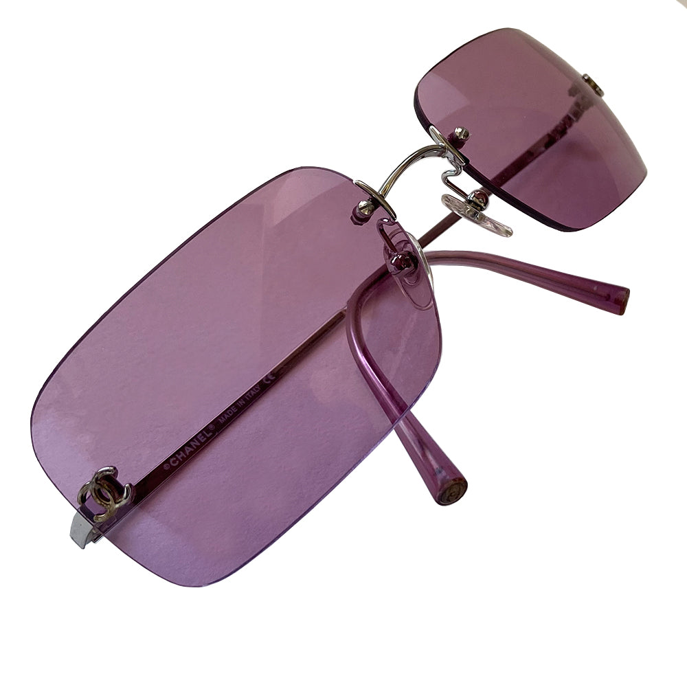 Chanel rimless lens CC logo sunglasses circa 2007 with silver-tone metal arms and Chanel engraved at top of bridge with rimless rectangular purple lenses and inset interlocking CC logos at each lens edge. Style: 4017 Case and cleaning cloth included. Made in Italy