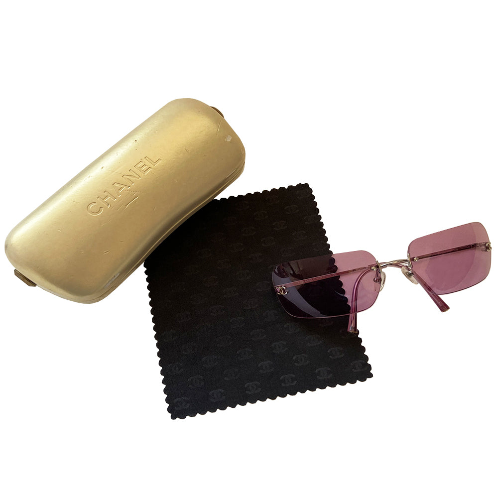 Chanel rimless lens CC logo sunglasses circa 2007 with silver-tone metal arms and Chanel engraved at top of bridge with rimless rectangular purple lenses and inset interlocking CC logos at each lens edge. Style: 4017 Case and cleaning cloth included. Made in Italy