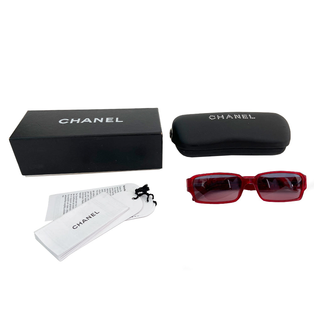 Rectangle Swarovski Sunglasses in red circa 1990’s, excellent condition, no scratching on lenses with rectangular acetate frames and gradient lenses that transition from grey to red. CHANEL printed out on each arm in swarovski crystals Style: 5060-B. Original box, case and cleaning cloth and cards included. All in excellent condition