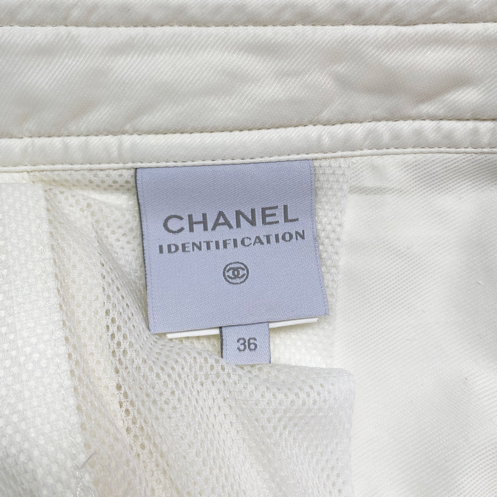 Chanel Identification white sport pants from 2001. High waisted with banded side slash pockets and back flap pockets with silver CC logo snap. Rubber identification silver and white logo at waist. Chanel logo metal toggles cinch the bottom hem. Zipper at knee removes lower leg convertible to shorts. Made in Italy