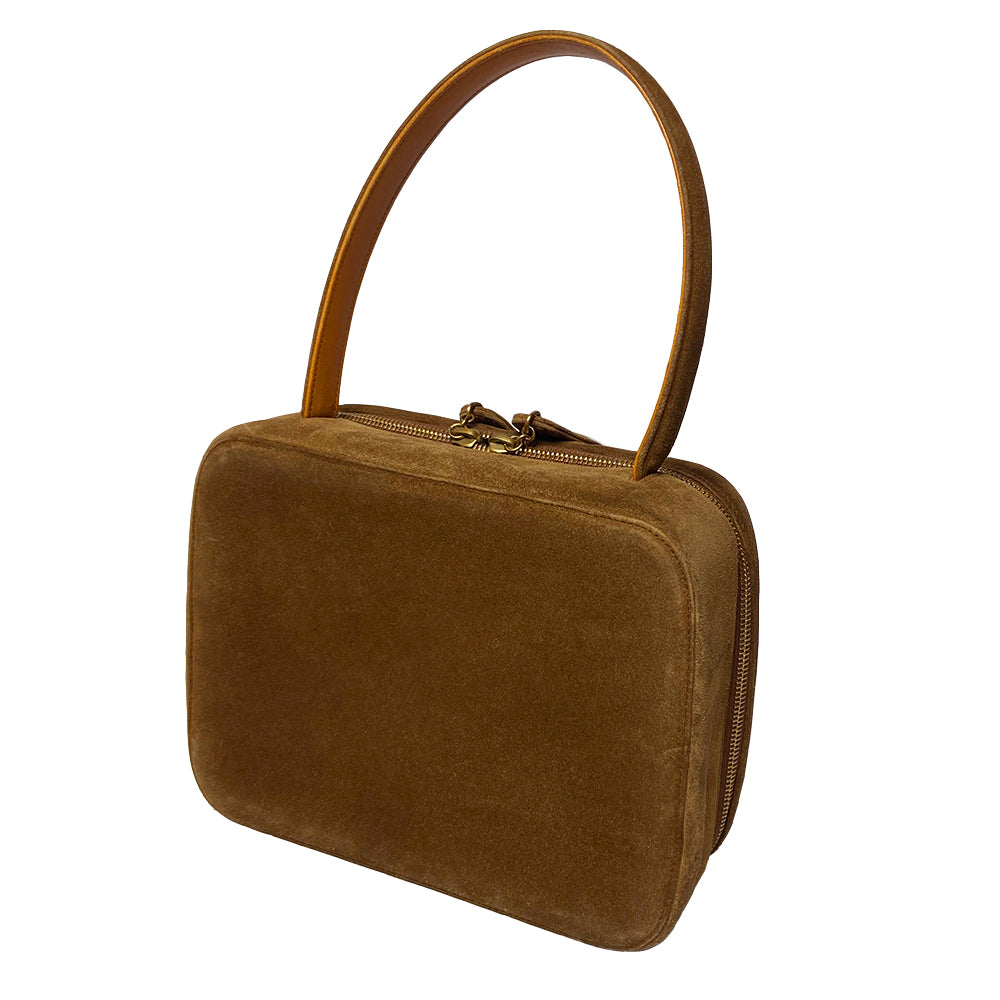 Chanel tobacco suede vanity case by Karl Lagerfeld for Chanel 1997-1999. Rectangular top handle bag with interlocking stitched CC logo at front, dual suede paddle zipper pull closure, chocolate leather interior with one zippered pocket and one slip pocket. Serial number sticker attached. Made in Italy