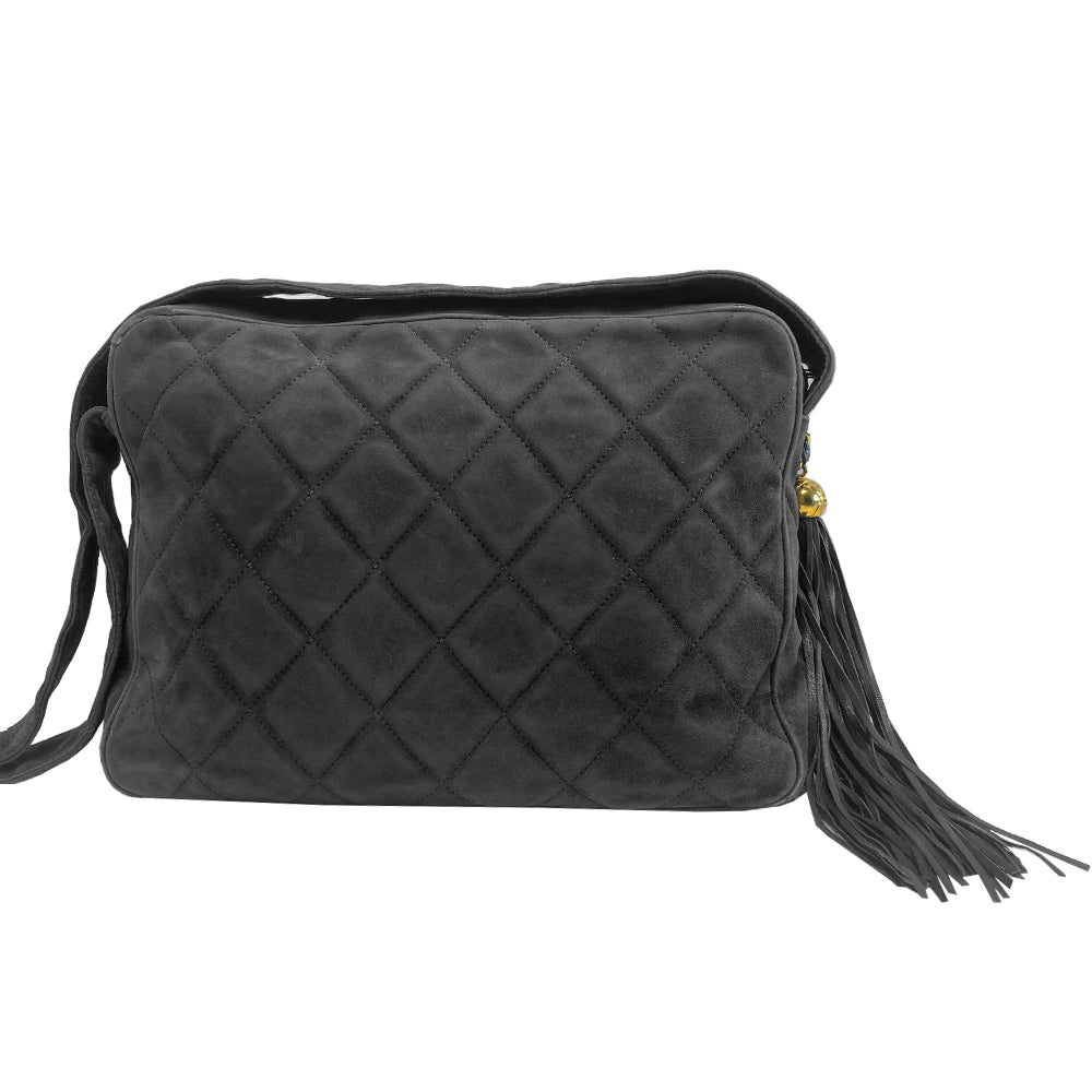 Chanel quilted CC logo crossbody charcoal grey shoulder bag with suede strap by Karl Lagerfeld for Chanel, 1995 with etched gold ball and tassels zipper pull, outer flap pocket with black leather lining, interior zippered pocket. Made in France