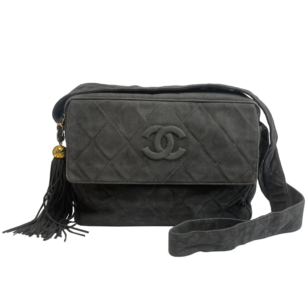 Chanel quilted CC logo crossbody charcoal grey shoulder bag with suede strap by Karl Lagerfeld for Chanel, 1995 with etched gold ball and tassels zipper pull, outer flap pocket with black leather lining, interior zippered pocket. Made in France
