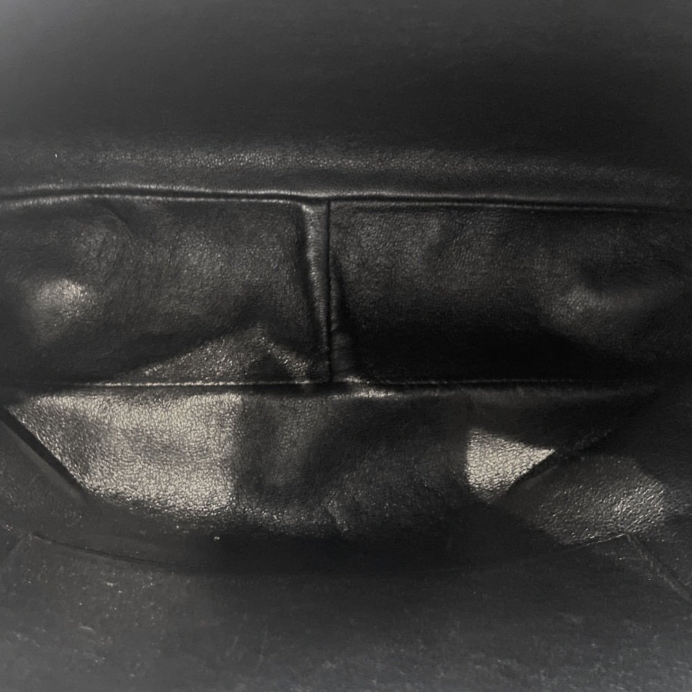 Chanel quilted CC logo crossbody charcoal grey shoulder bag with suede strap by Karl Lagerfeld for Chanel, 1995 with etched gold ball and tassels zipper pull, outer flap pocket with black leather lining, interior zippered pocket. Made in France