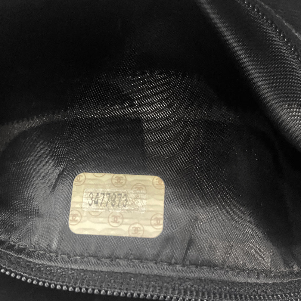 Chanel quilted CC logo crossbody charcoal grey shoulder bag with suede strap by Karl Lagerfeld for Chanel, 1995 with etched gold ball and tassels zipper pull, outer flap pocket with black leather lining, interior zippered pocket. Made in France