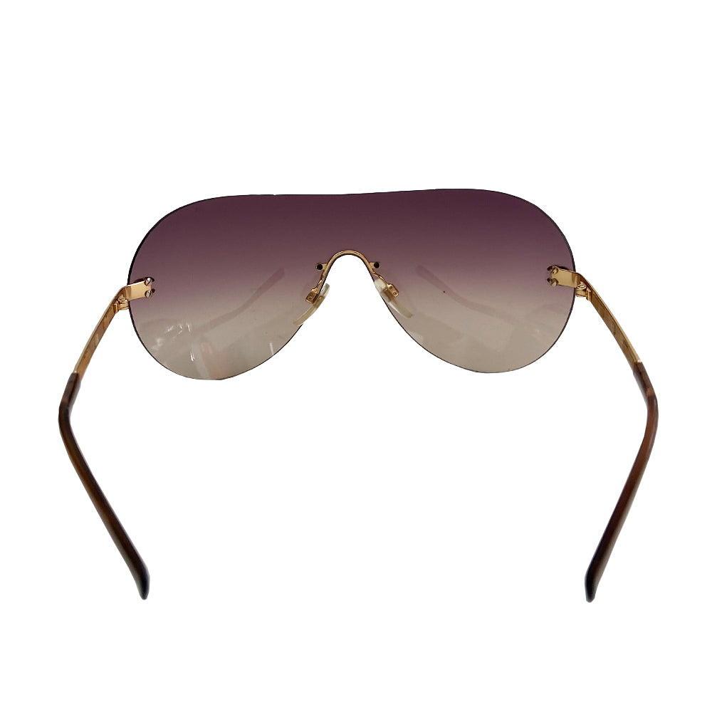 Chanel CC Leather Threaded Shield Sunglasses from mid 2000’s Oversized dark bronze gradient single shield lense and gold-tone metal arms with leather threaded through each arm. CC logo in gold on either side of frame at arm. Black quilted case included. Made in Italy.