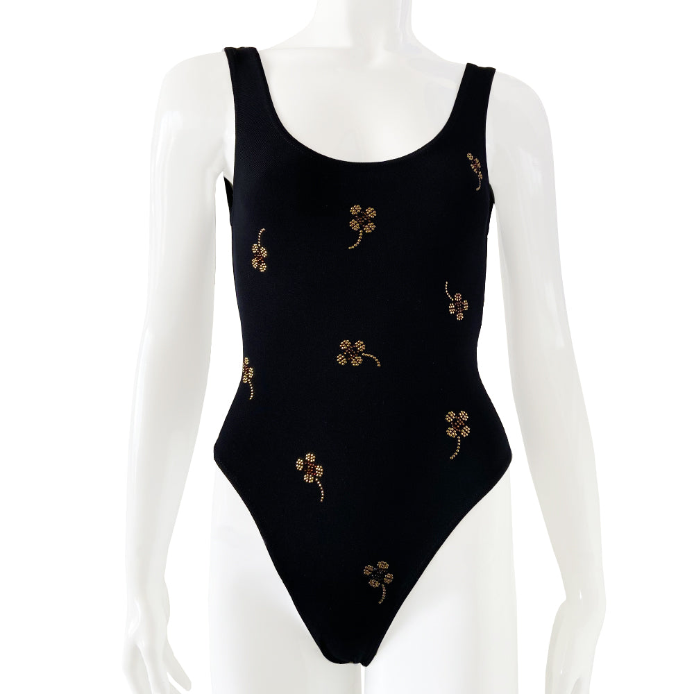 Chanel crystal appliqué embellished clover one-piece swimsuit by Karl Lagerfeld for Chanel 2001 Cruise Collection. Solid black stretch grosgrain fabric one-piece swimsuit with low back, front embellishments of tiny gold and bronze-tone appliqué crystal cc logo clovers and single logo clover in back. Size 36. Made in France