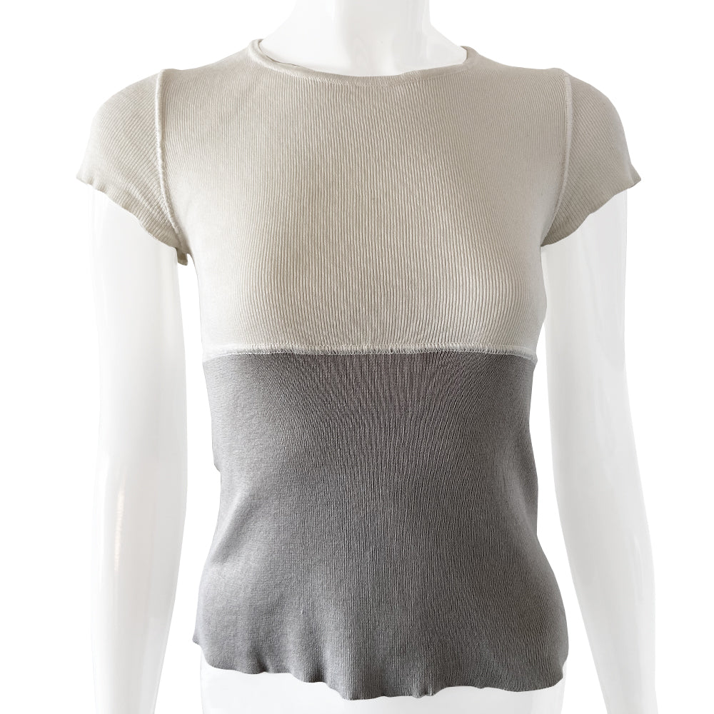 Chanel Logo Short Sleeve Knit top by Karl Lagerfeld for Chanel Spring 2001. Short sleeved two-tone color block fine rib knit with rounded ribbed edge neckline and larger ribbing at sleeves Interlocking box CC logo centered at upper back. 100% cotton in cream/grey Size: FR 36