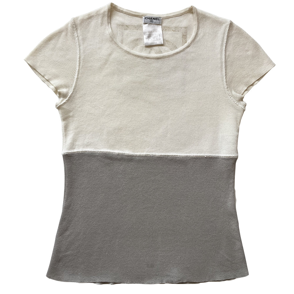 Chanel Logo Short Sleeve Knit top by Karl Lagerfeld for Chanel Spring 2001. Short sleeved two-tone color block fine rib knit with rounded ribbed edge neckline and larger ribbing at sleeves Interlocking box CC logo centered at upper back. 100% cotton in cream/grey Size: FR 36