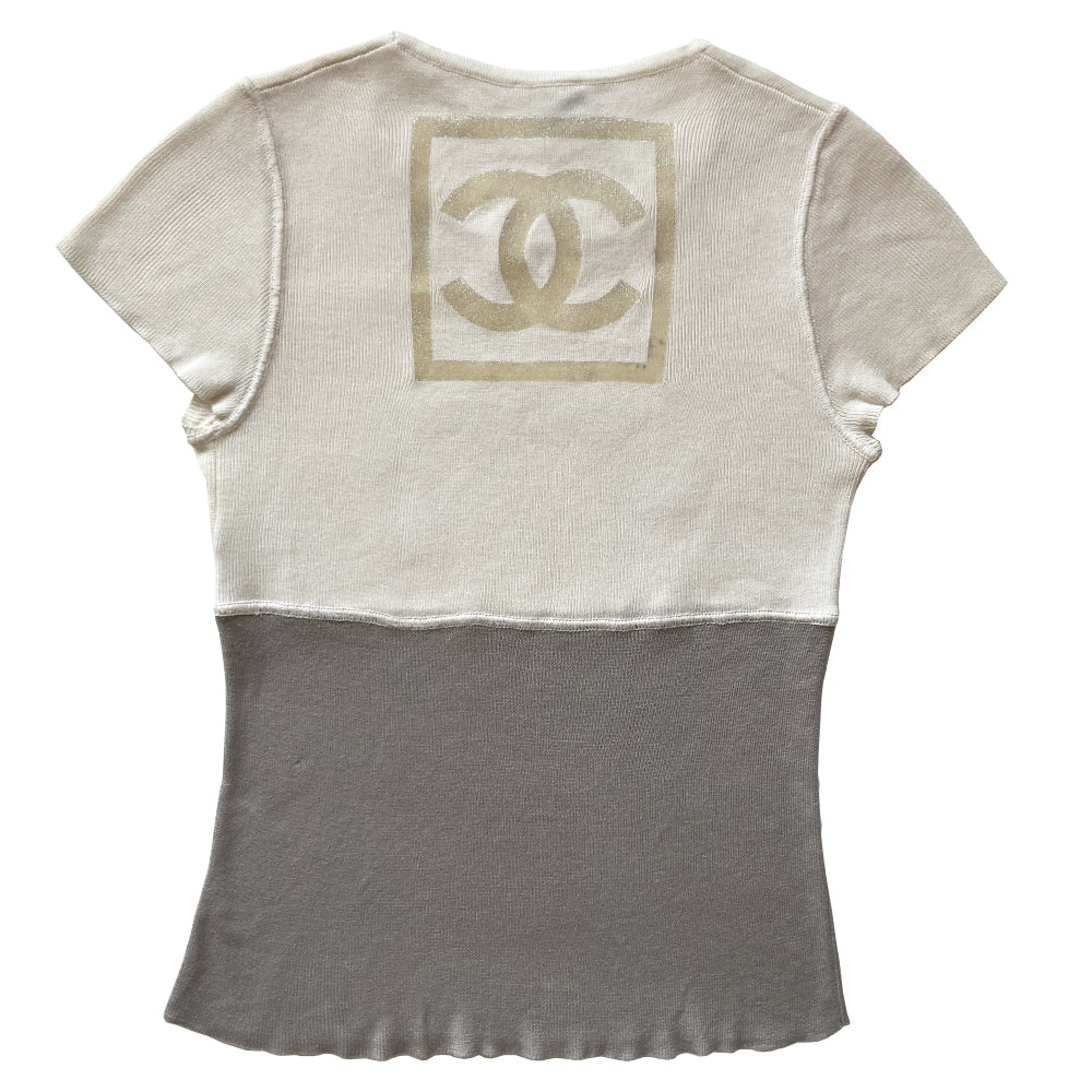 Chanel Logo Short Sleeve Knit top by Karl Lagerfeld for Chanel Spring 2001. Short sleeved two-tone color block fine rib knit with rounded ribbed edge neckline and larger ribbing at sleeves Interlocking box CC logo centered at upper back. 100% cotton in cream/grey Size: FR 36