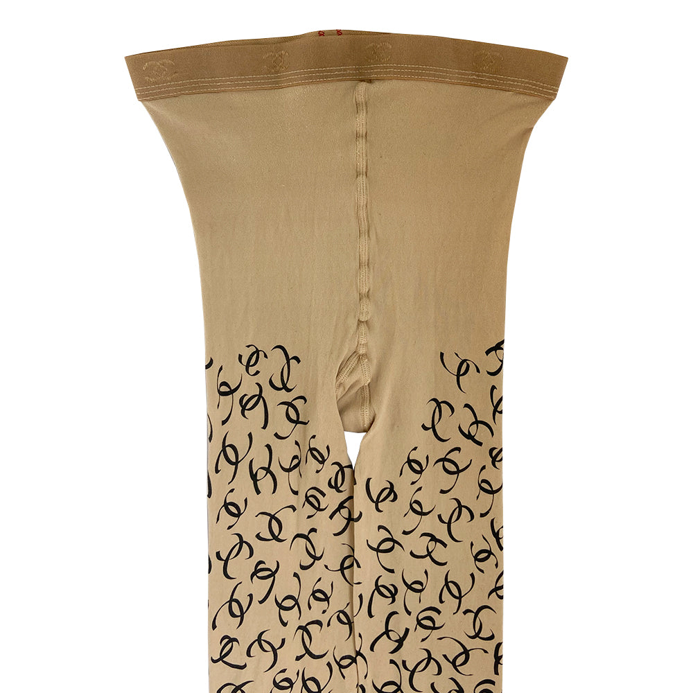 Chanel ribbon CC logo tights, fall 2000 RTW runway by Karl Lagerfeld for Chanel in neutral beige color "patterned fancy tights” with all over ribbon design black CC logos, interlocking CC logos at waistband, cotton gusset, reinforced toes. Made in France