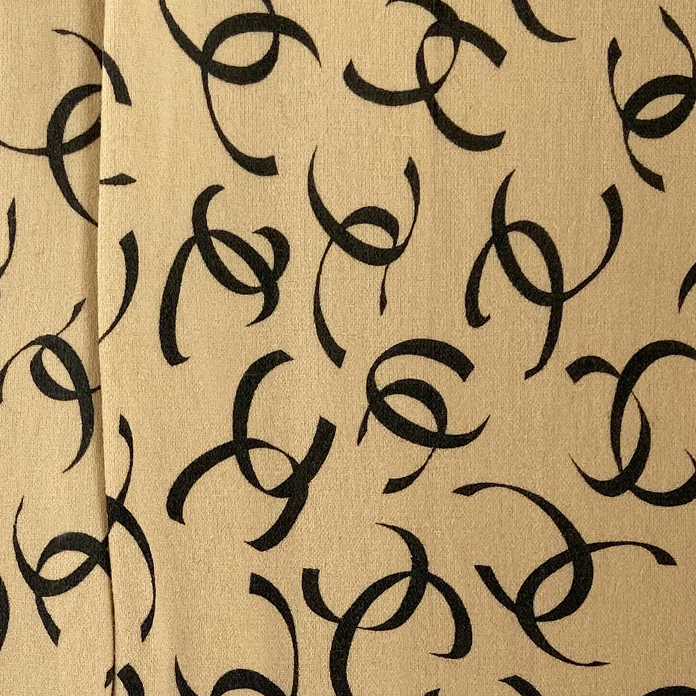 Chanel ribbon CC logo tights, fall 2000 RTW runway by Karl Lagerfeld for Chanel in neutral beige color "patterned fancy tights” with all over ribbon design black CC logos, interlocking CC logos at waistband, cotton gusset, reinforced toes. Made in France