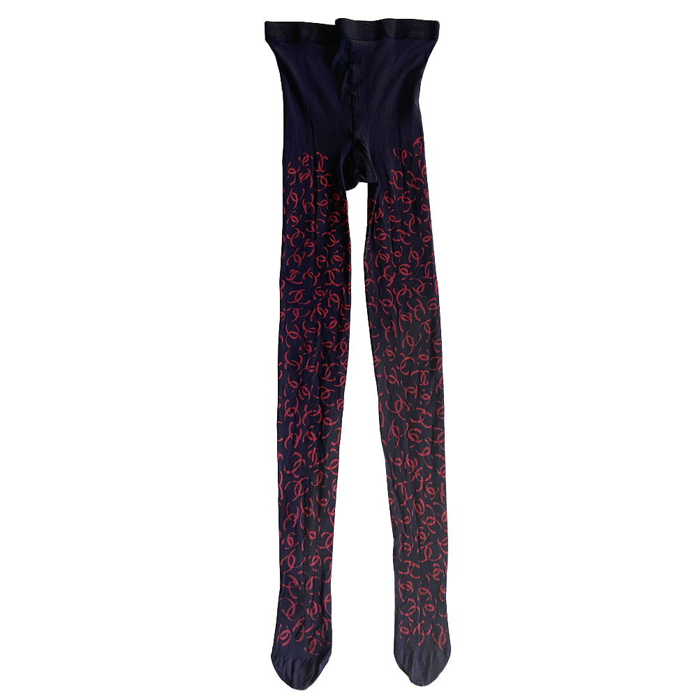 Chanel CC logo tights from Fall 2000 RTW runway collection by Karl Lagerfeld for Chanel. Blue color "patterned fancy tights” with all over ribbon design red CC logos, interlocking CC logos at waistband, cotton gusset, reinforced toes. Made in France