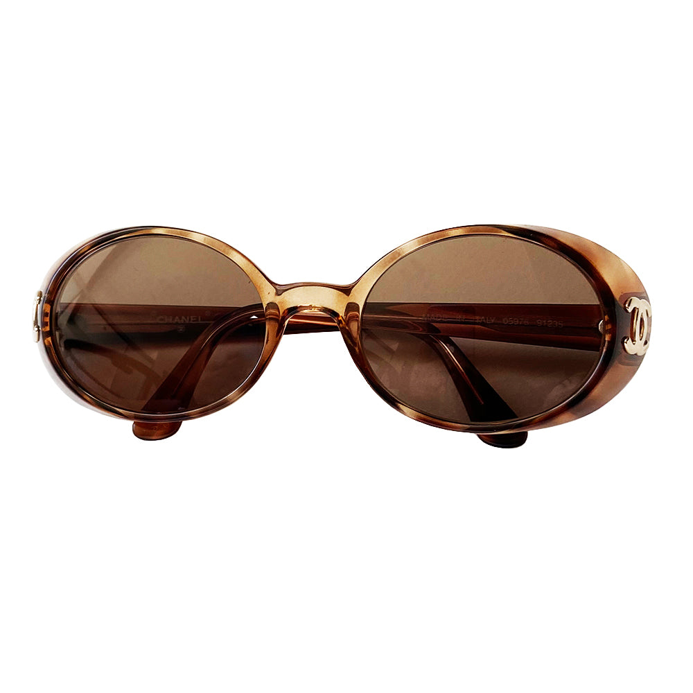 Chanel 1990’s Oval tortoise frame with goggle sunglasses from Karl Lagerfeld for Chanel 1990’s iconic sunglasses. Acetate frames with dark brown lenses and interlocking CC gold logos at temple. Style: 05976 91235 Case not included. Made in Italy