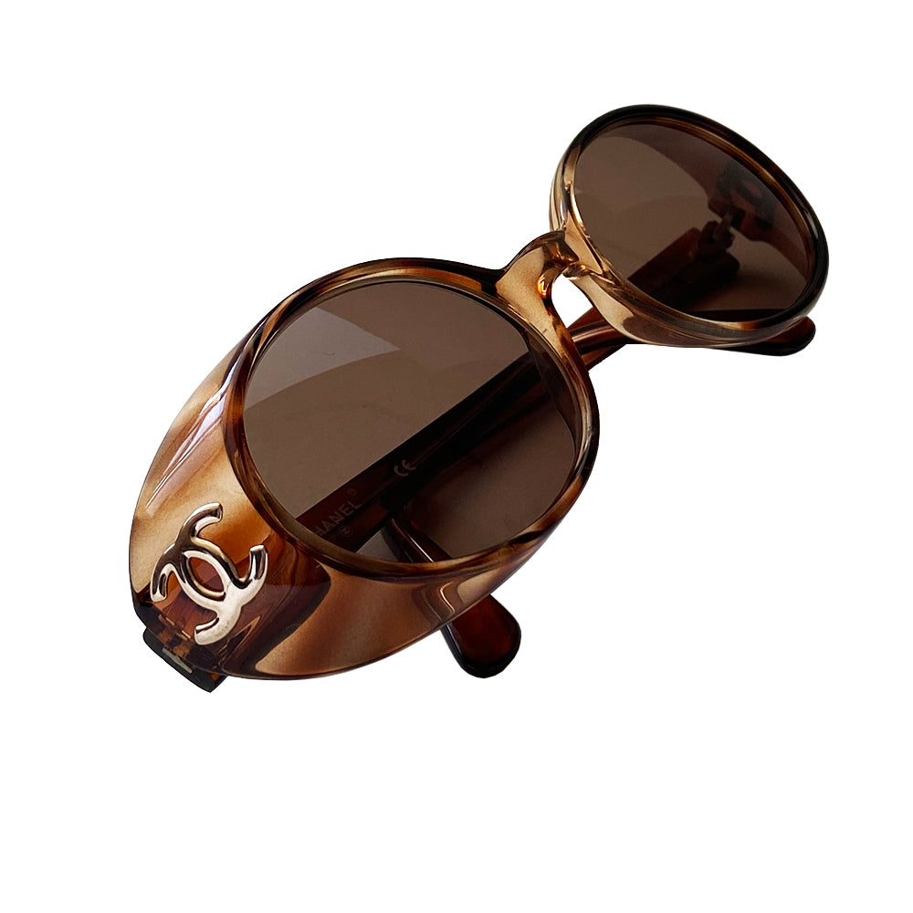 Chanel 1990’s Oval tortoise frame with goggle sunglasses from Karl Lagerfeld for Chanel 1990’s iconic sunglasses. Acetate frames with dark brown lenses and interlocking CC gold logos at temple. Style: 05976 91235 Case not included. Made in Italy