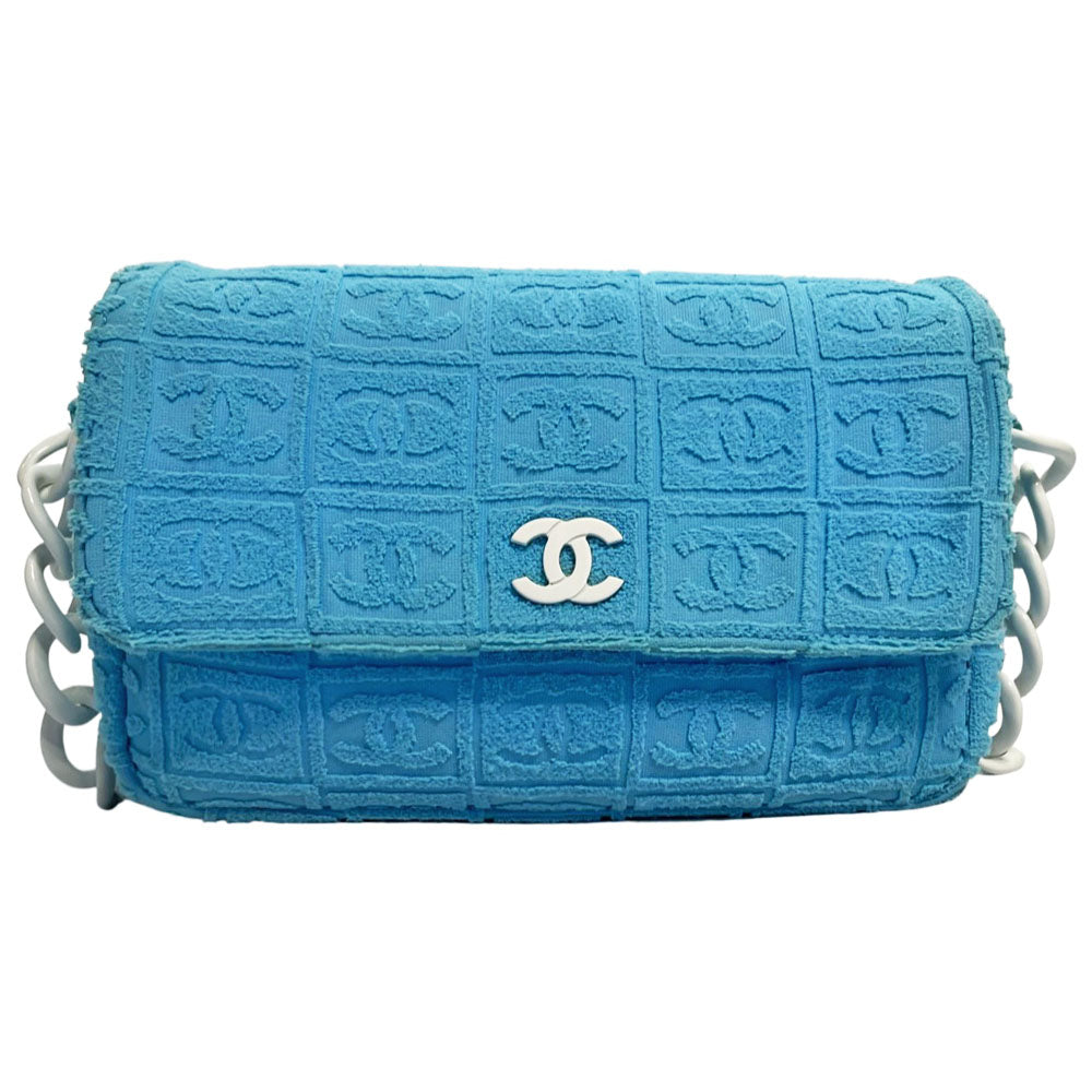 Chanel sky blue blue terry towel flap bag Karl Lagerfeld for Chanel 2002 with all over boxed cc logo embossed terry cloth flap bag with bold white acrylic chain strap, white cc front logo at flap, white zipper closure, white leather lining with one pvc pocket and 1 slip pocket. Made in Italy