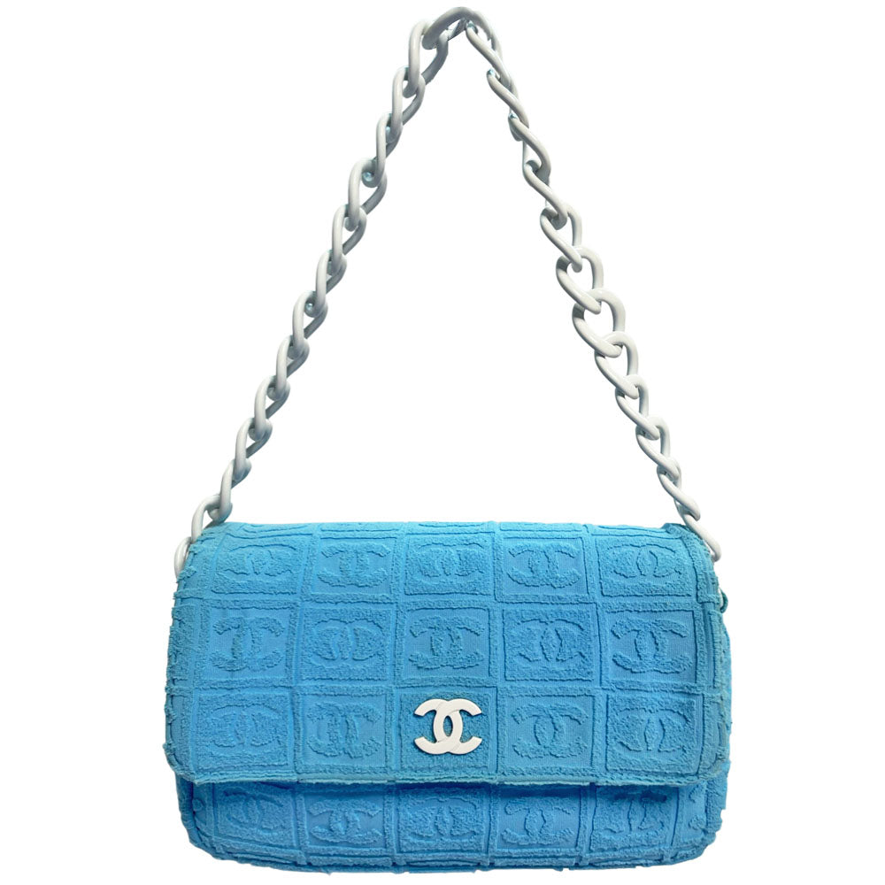 Chanel sky blue blue terry towel flap bag Karl Lagerfeld for Chanel 2002 with all over boxed cc logo embossed terry cloth flap bag with bold white acrylic chain strap, white cc front logo at flap, white zipper closure, white leather lining with one pvc pocket and 1 slip pocket. Made in Italy