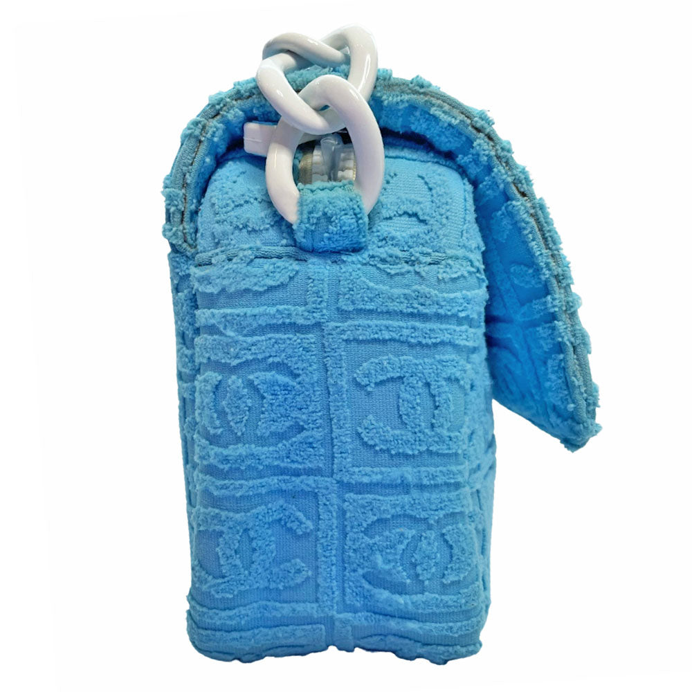 Chanel sky blue blue terry towel flap bag Karl Lagerfeld for Chanel 2002 with all over boxed cc logo embossed terry cloth flap bag with bold white acrylic chain strap, white cc front logo at flap, white zipper closure, white leather lining with one pvc pocket and 1 slip pocket. Made in Italy