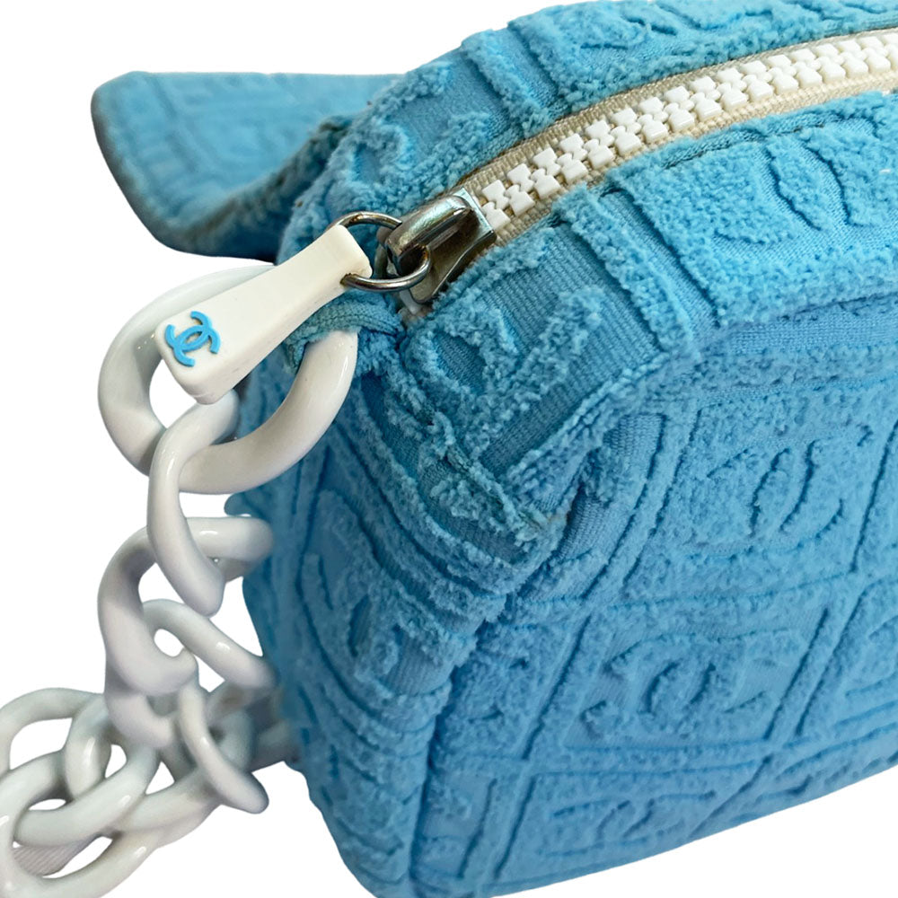 Chanel sky blue blue terry towel flap bag Karl Lagerfeld for Chanel 2002 with all over boxed cc logo embossed terry cloth flap bag with bold white acrylic chain strap, white cc front logo at flap, white zipper closure, white leather lining with one pvc pocket and 1 slip pocket. Made in Italy