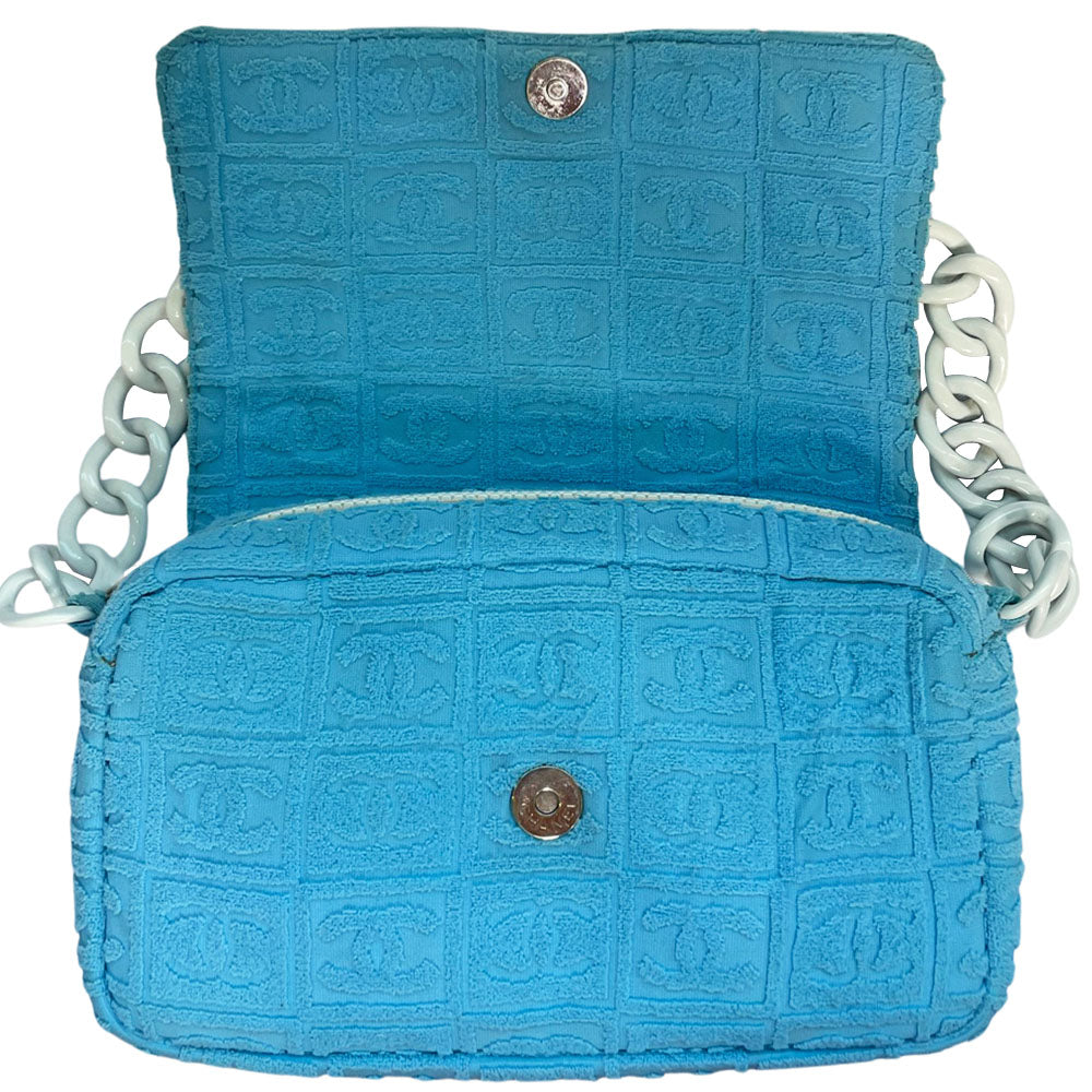Chanel sky blue blue terry towel flap bag Karl Lagerfeld for Chanel 2002 with all over boxed cc logo embossed terry cloth flap bag with bold white acrylic chain strap, white cc front logo at flap, white zipper closure, white leather lining with one pvc pocket and 1 slip pocket. Made in Italy