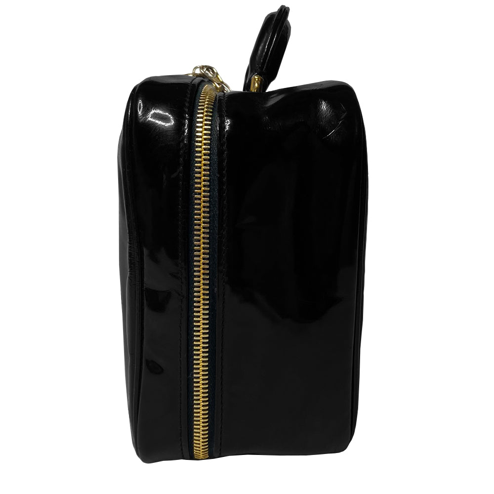 Chanel patent leather vanity case by Karl Lagerfeld for Chanel 1996 with interlocking CC logo at front, dual logo zipper pull closure, top carry handle and removable long strap. Leather interior with inner flap that snaps to side, zippered pocket with logo zipper pull, serial number sticker attached. Made in Italy