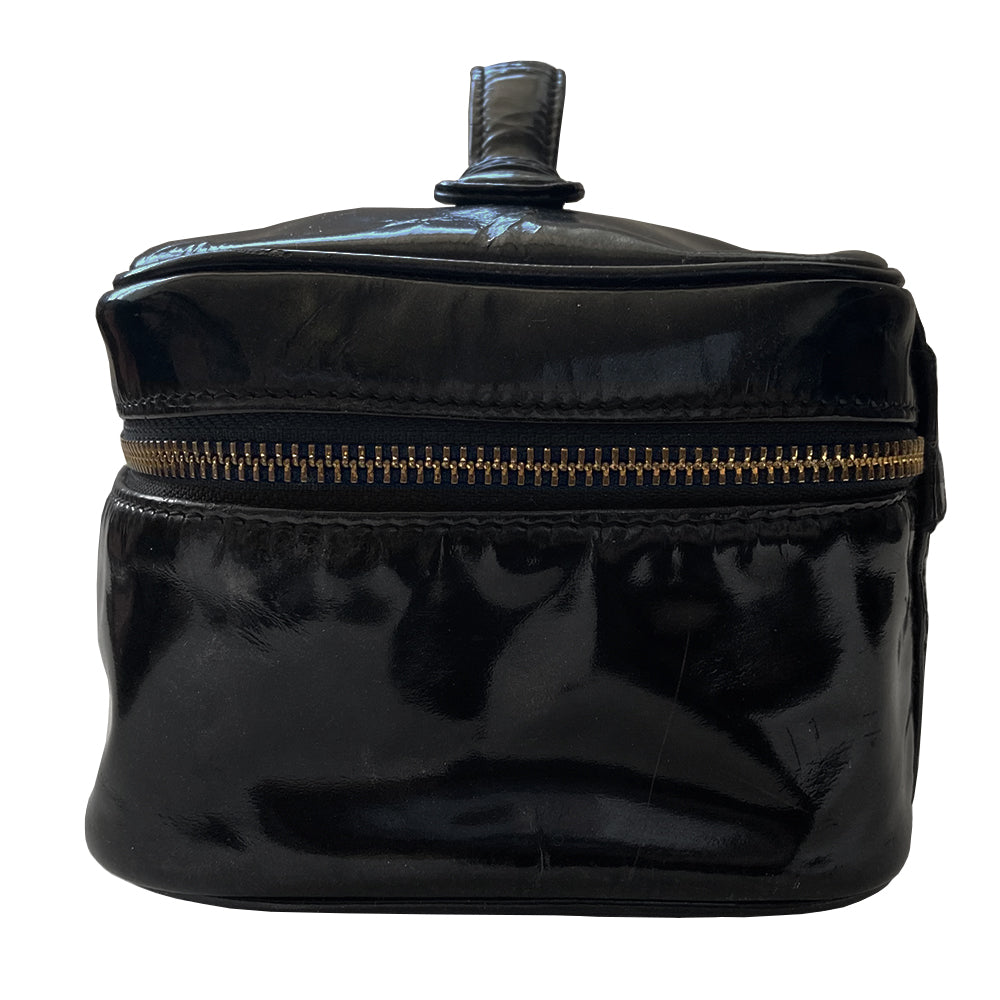 Chanel black patent leather vanity case by Karl Lagerfeld for Chanel 1996-1997 Rectangular bag with stitched interlocking CC logo at front, top handle, zip around closure with leather disc zipper pull embellished with gold CC logo. Leather interior with inner slip pocket pouch, Chanel stamped inside. Made in Italy