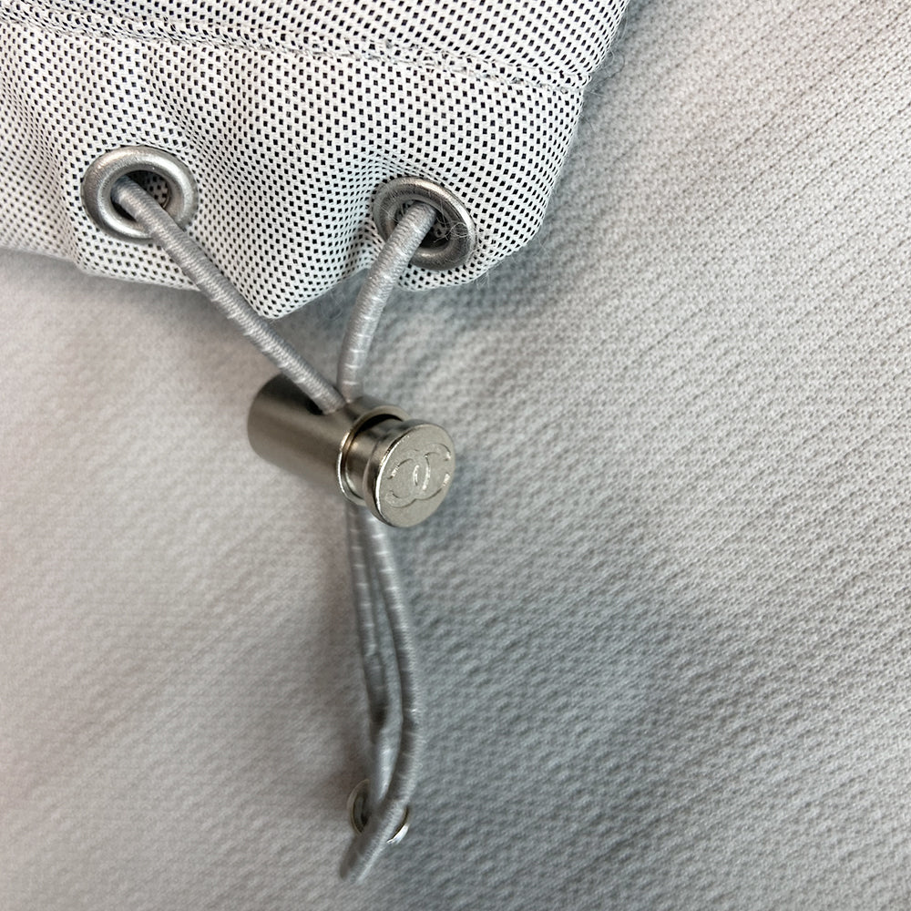 Chanel Identification logo collarless zip front grey vest/top by Karl Lagerfeld for Chanel, spring 2001 with box CC logo appliqué in back, CC logo engraved zipper pull and silver-tone toggles that adjust the elastic cording at bottom hemline. Made in Italy