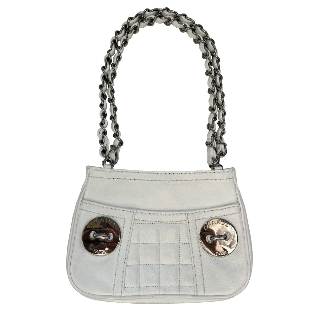 White Chanel Button Chain Quilted Shoulder Bag with 2 Gunmetal front buttons and 2 gunmetal chain link and interwoven leather straps, exterior quilted front pocket. Magnetic snap button closure, burgundy textile jacquard Chanel lining. Chanel Paris engraved on inside clasp. Interior hologram date code tag attached.
