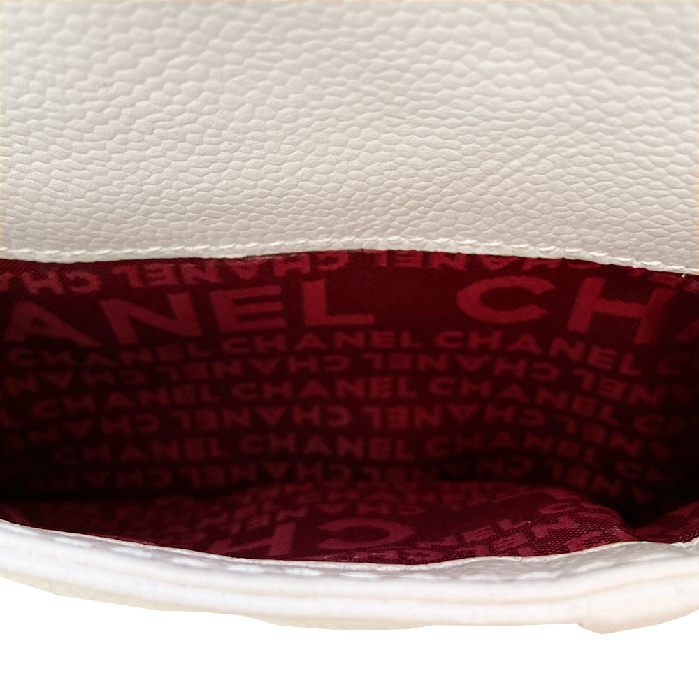 White Chanel Button Chain Quilted Shoulder Bag with 2 Gunmetal front buttons and 2 gunmetal chain link and interwoven leather straps, exterior quilted front pocket. Magnetic snap button closure, burgundy textile jacquard Chanel lining. Chanel Paris engraved on inside clasp. Interior hologram date code tag attached.