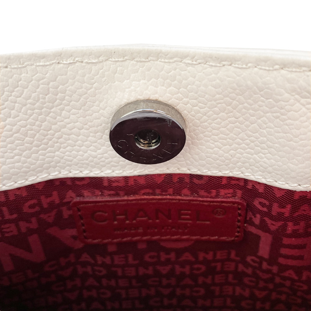 White Chanel Button Chain Quilted Shoulder Bag with 2 Gunmetal front buttons and 2 gunmetal chain link and interwoven leather straps, exterior quilted front pocket. Magnetic snap button closure, burgundy textile jacquard Chanel lining. Chanel Paris engraved on inside clasp. Interior hologram date code tag attached.