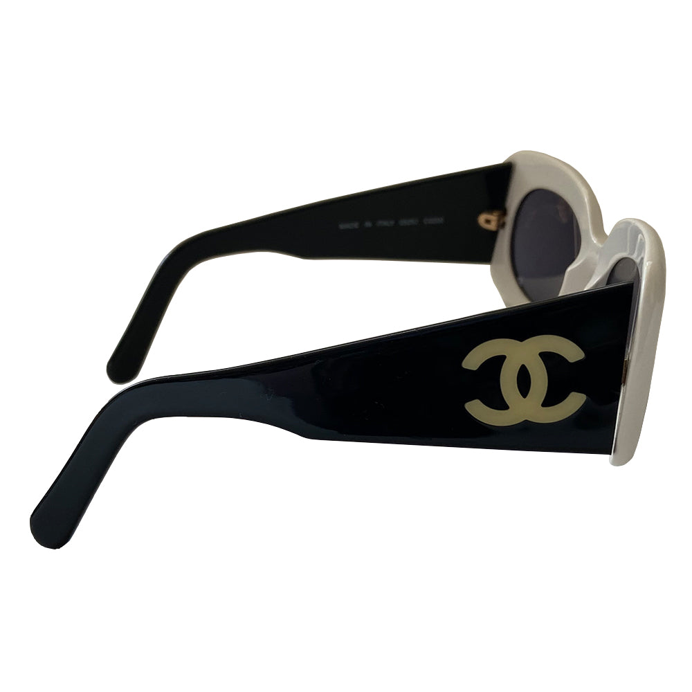 Chanel Black & White acetate frame sunglasses from Spring 1995 by Karl Lagerfeld for Chanel RTW runway. Butterfly style white frames with thick black side arms and charcoal lenses Interlocking gold-tone inset CC logos at each arm Style: 05252 C0200. Made in Italy
